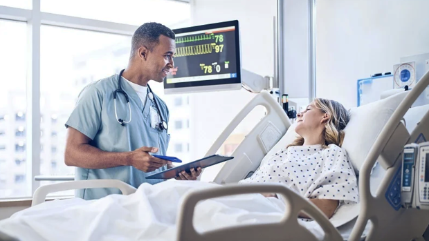 Doctor talking to patient in bed