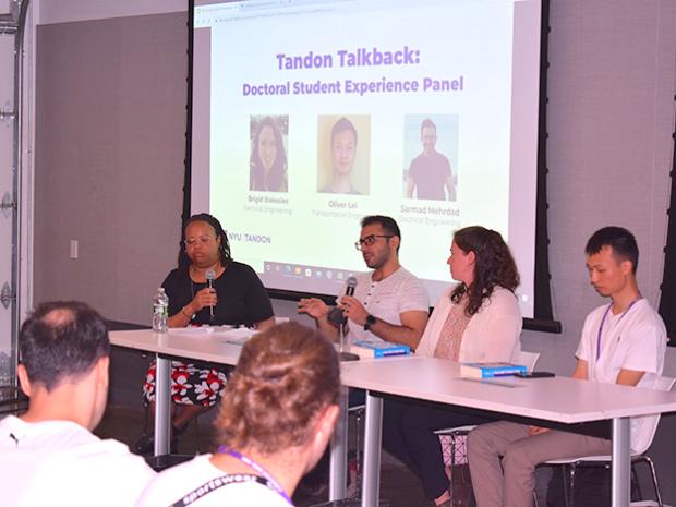 PhD students sitting on a panel at new student event